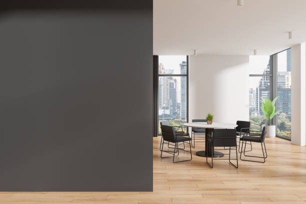 istock Modern interior with round table and chairs, cityscape visible through large windows, light-colored wooden floor, concept of home design, home decor.  3D Rendering 2166280000
