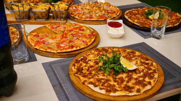 istock Pizza and Fries on a Tabletop 2166280020