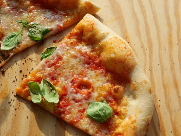 istock pizza slice with salami, vegetables, cheese, and pineapple 2166287295