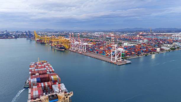 istock Cargo container ship carrying container and running in international container port customs shipyard sea port concept smart logistic service. Container Ship. 2166291231