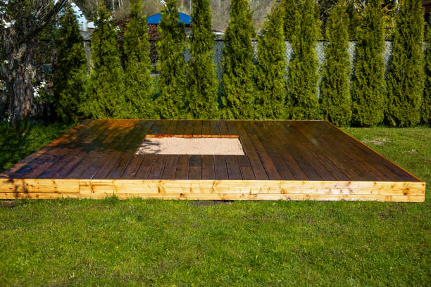 istock Freshly stained wooden deck with a central sandpit in a backyard surrounded by trees and bushes 2166294370