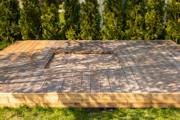 istock Wooden deck with central sandpit in a backyard setting, surrounded by trees and natural surroundings 2166294376