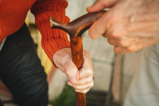 Senior woman's hand with a walking cane