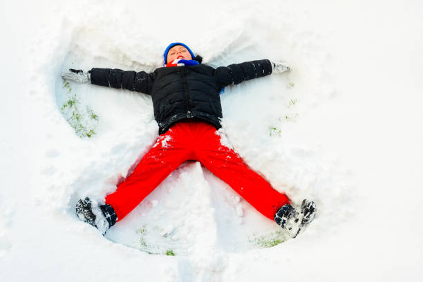 istock An angel in the snow made by a boy. 2166297555