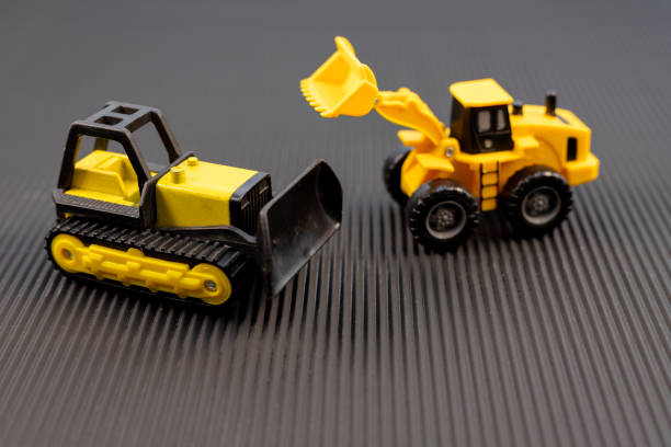 istock Yellow Construction Toy Vehicles on Black Background 2166299105