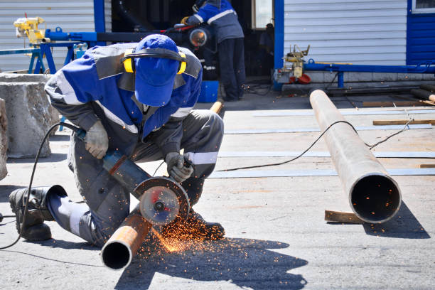 istock Worker Cutting Steel Pipe Outdoors at Construction Site in Bright Daylight 2166299482