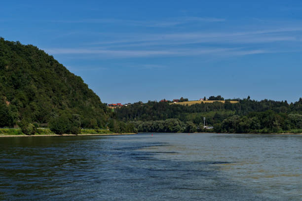 Green water of the river Inn joining the dark water from Danube river in Passau