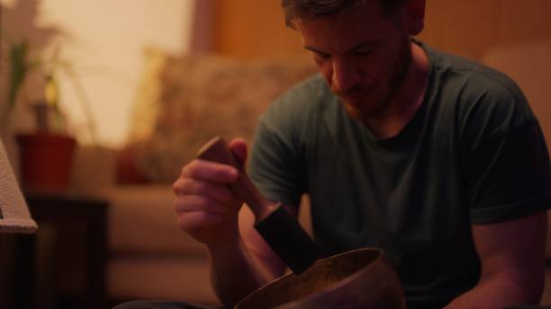 istock Man using Tibetan bowl for music therapy session 2166300443