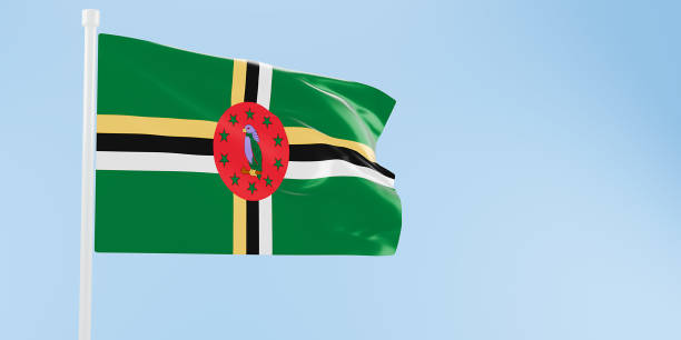 Small paper flag of Dominica pinned. Isolated on white background. Horizontal orientation. Close up photography. Copy space.