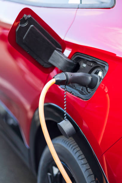 istock red electric car charging at charging station 2166303015