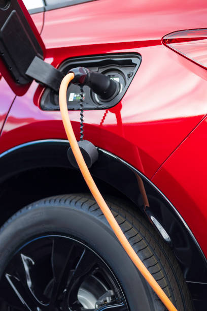 istock red electric car charging at charging station 2166303032