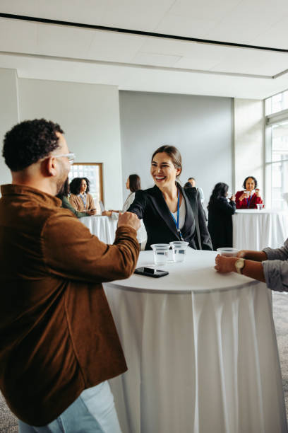 istock Networking and refreshments: Corporate professionals mingling at an event 2166303513