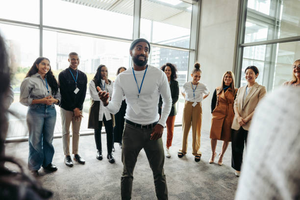 istock Confident businessman leading an engaging team-building session in a modern office 2166303739