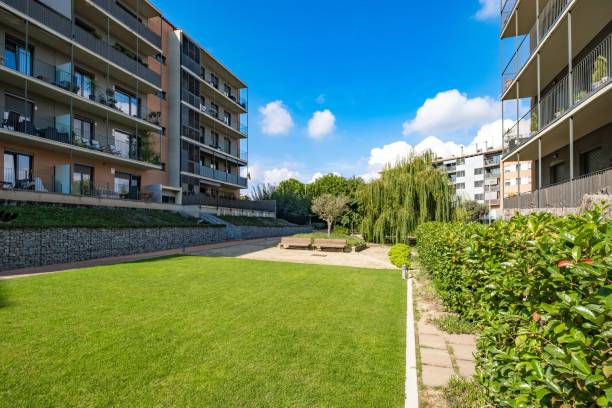 istock Modern residential complex with green lawns, benches, and a clear blue sky in Spain 2166304231