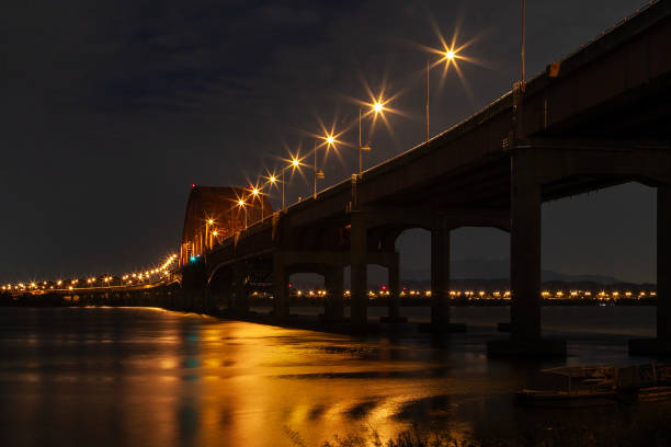 istock illuminated bridge on the river in the night 2166304244