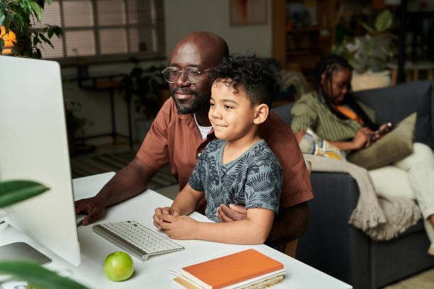 istock Father and son in front of computer 2166304994