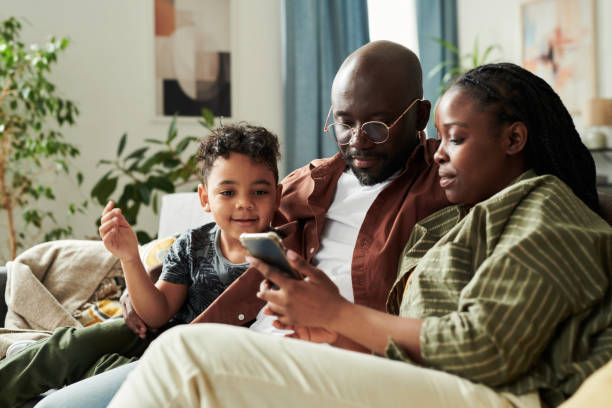 istock Family looking at smartphone screen 2166305020