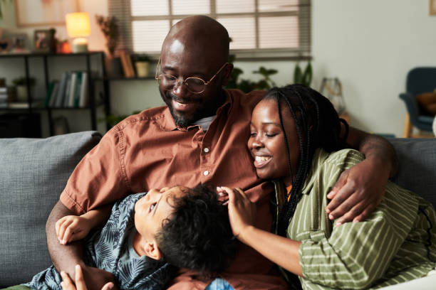 istock Parents and their son relaxing on couch 2166305058