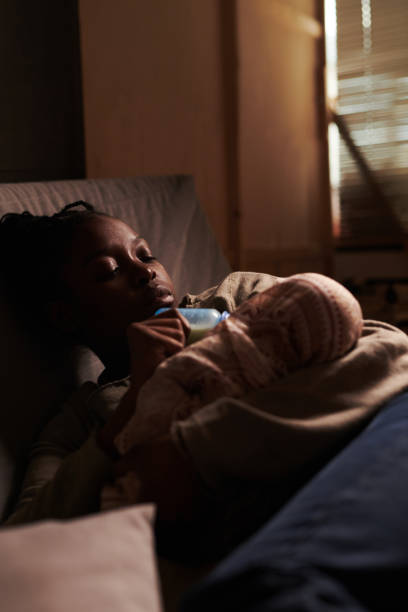 istock Young tired woman feeding her baby 2166307113