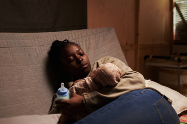 istock Tired single mother with newborn baby 2166307147