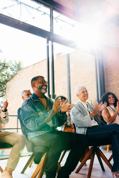 istock Colleagues attending seminar clapping in praise during assembly 2166307841