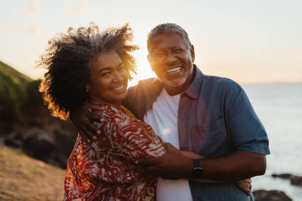 istock Retirement Bliss: Mature black couple embracing at sunset 2166309267