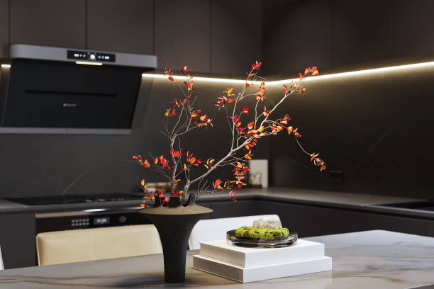 istock Modern kitchen interior bathed in sunlight with vibrant red flowers on the dining table 2166309381