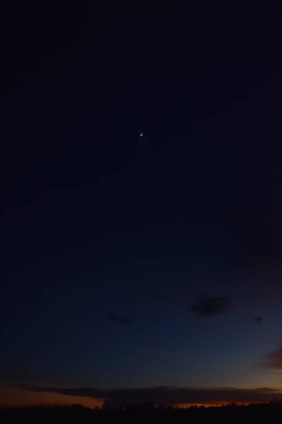 istock half moon floating on night sky at beach in twilight 2166310781