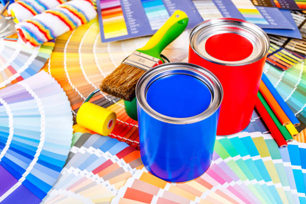 istock Painter and decorator work table with house project, color swatches, painting roller and paint brushes 2166311709