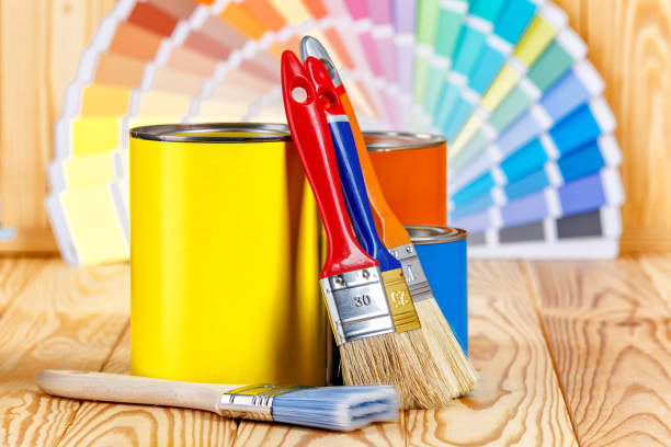 istock Painter and decorator work table with house project, color swatches, painting roller and paint brushes 2166311743
