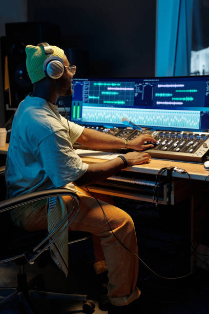istock Producer Working in Modern Music Studio with Large Mixing Board 2166312085