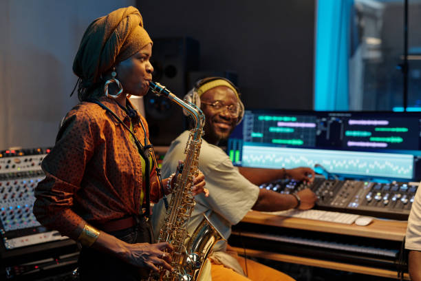 istock Playing Saxophone in Recording Studio with Music Equipment 2166312102