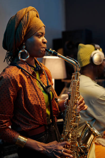 istock Playing Saxophone in a Cozy Indoor Setting 2166312112