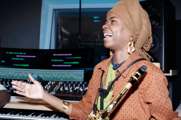istock Laughing Musician Holding Saxophone During Recording Session 2166312123