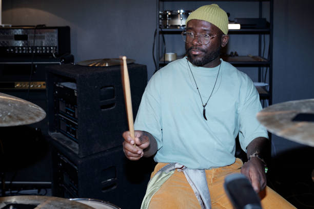 istock Playing Drums with Focus in Music Studio 2166312131