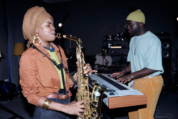 istock Playing Saxophone and Keyboard in Recording Studio 2166312132