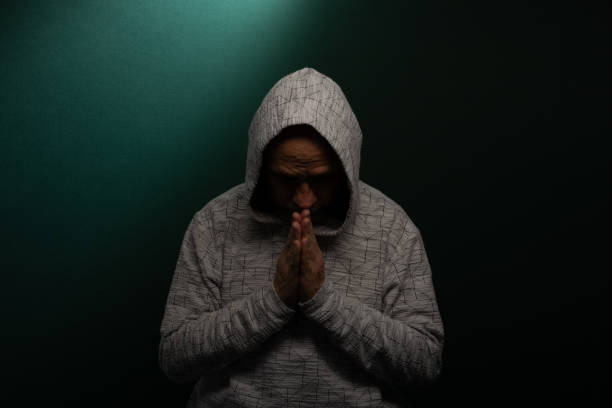 istock Mysterious man wearing hooded sweatshirt with head down. 2166313431