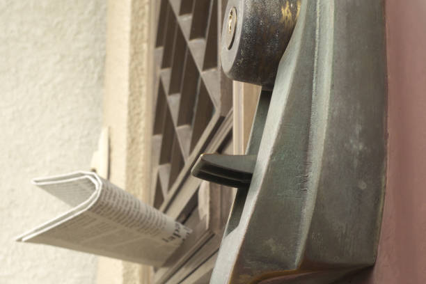 An entrance and a newspaper in the mailbox