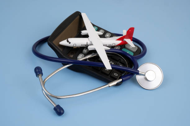istock Airplane on calculator and stethoscope on blue background. 2166325898