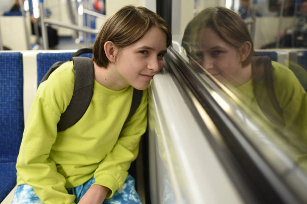 istock smiling 11 year old boy with backpack in train carriage, subway, metro 2166326695