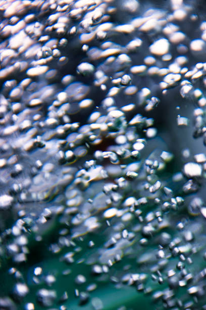 water air bubbles motion blur in a water cylinder reflections, abstract background