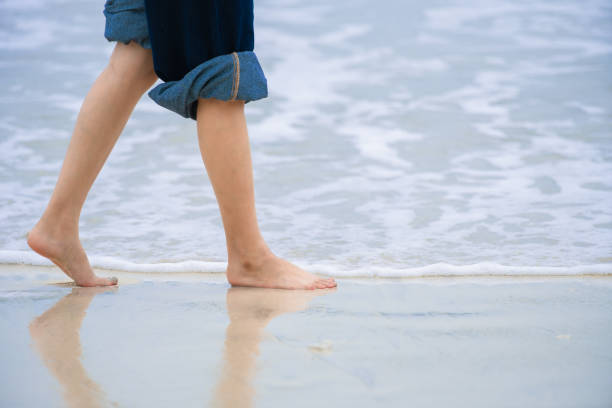 asian woman standing on the beach