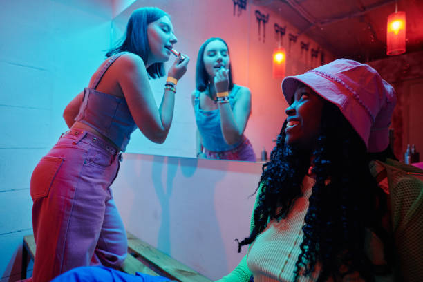 two cute intercultural girls in lavatory - aura fotos stockfoto's en -beelden