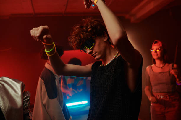 istock Guy dancing in neon lit night club 2166328502