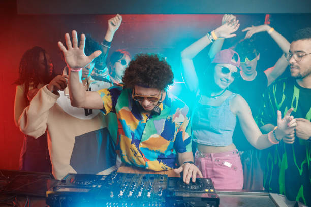 istock Excited deejay and dancers raising arms 2166328522