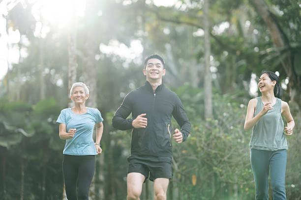 istock Cheerful people with mixed age range jogging together 2166329783