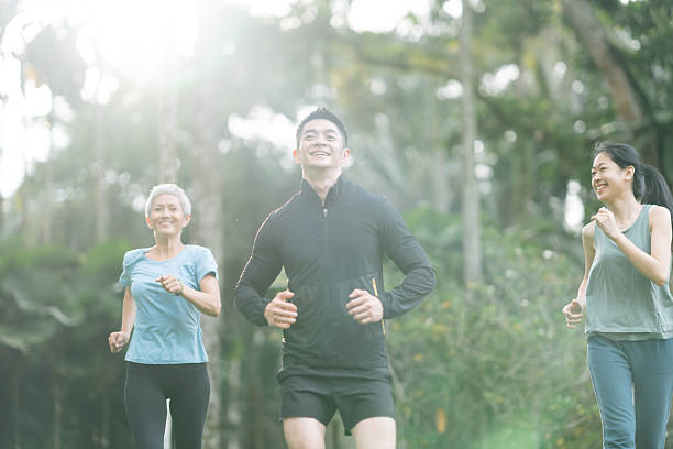 istock Cheerful people with mixed age range jogging together 2166329801