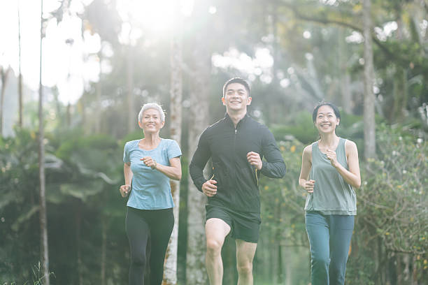 istock Cheerful people with mixed age range jogging together 2166329804