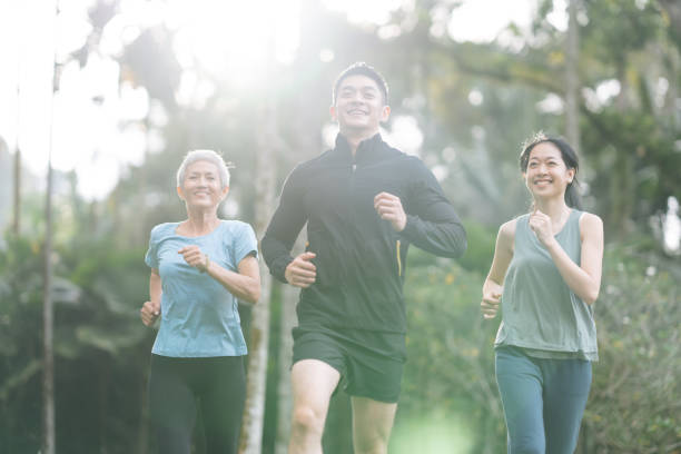 istock Cheerful people with mixed age range jogging together 2166329826
