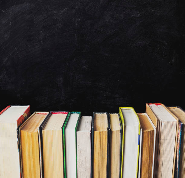 istock A row of books on a black chalkboard 2166330869